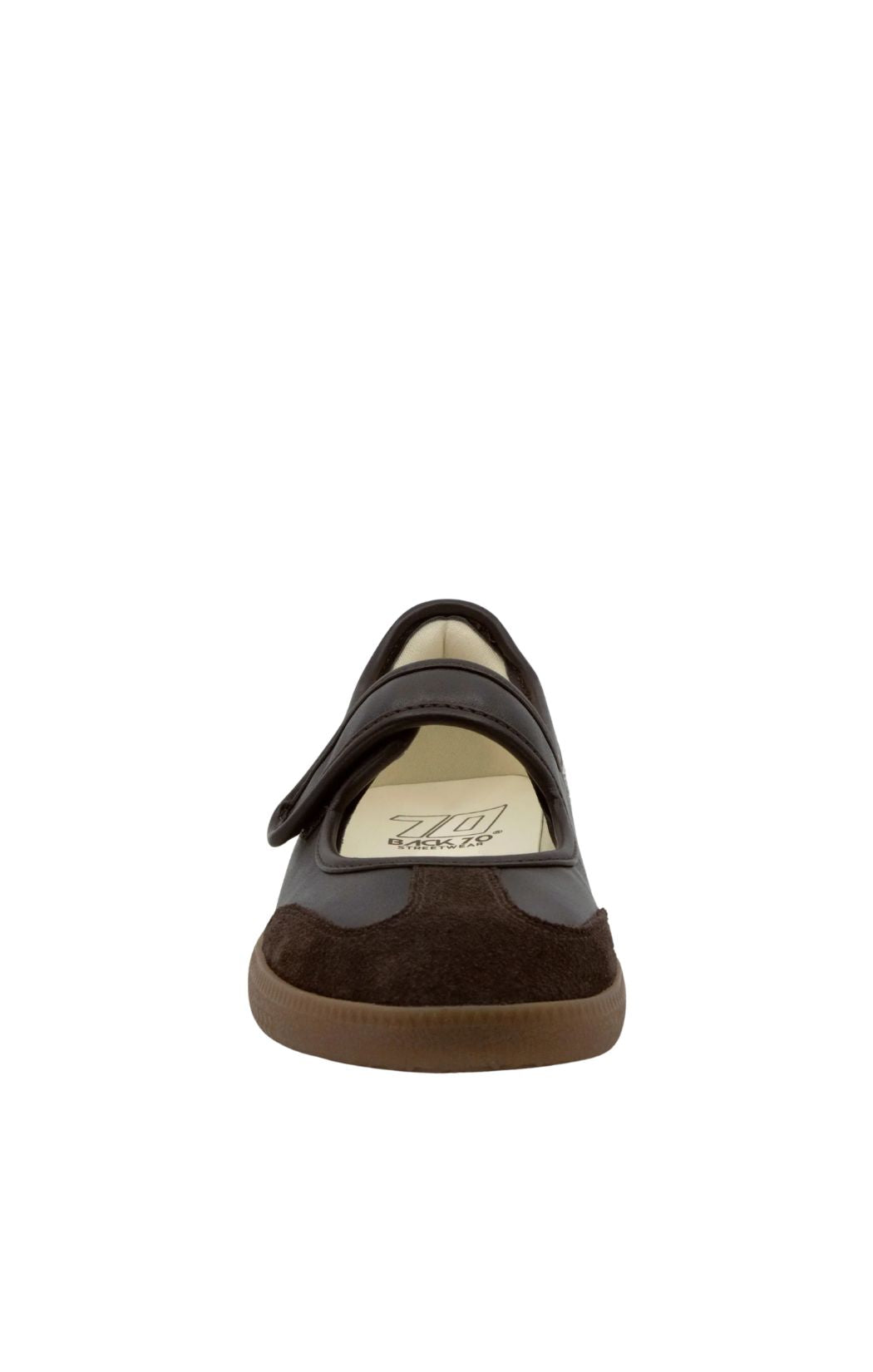 A single dark brown slip-on shoe with a hook-and-loop strap closure, shown from a rear three-quarter view against a plain white background.