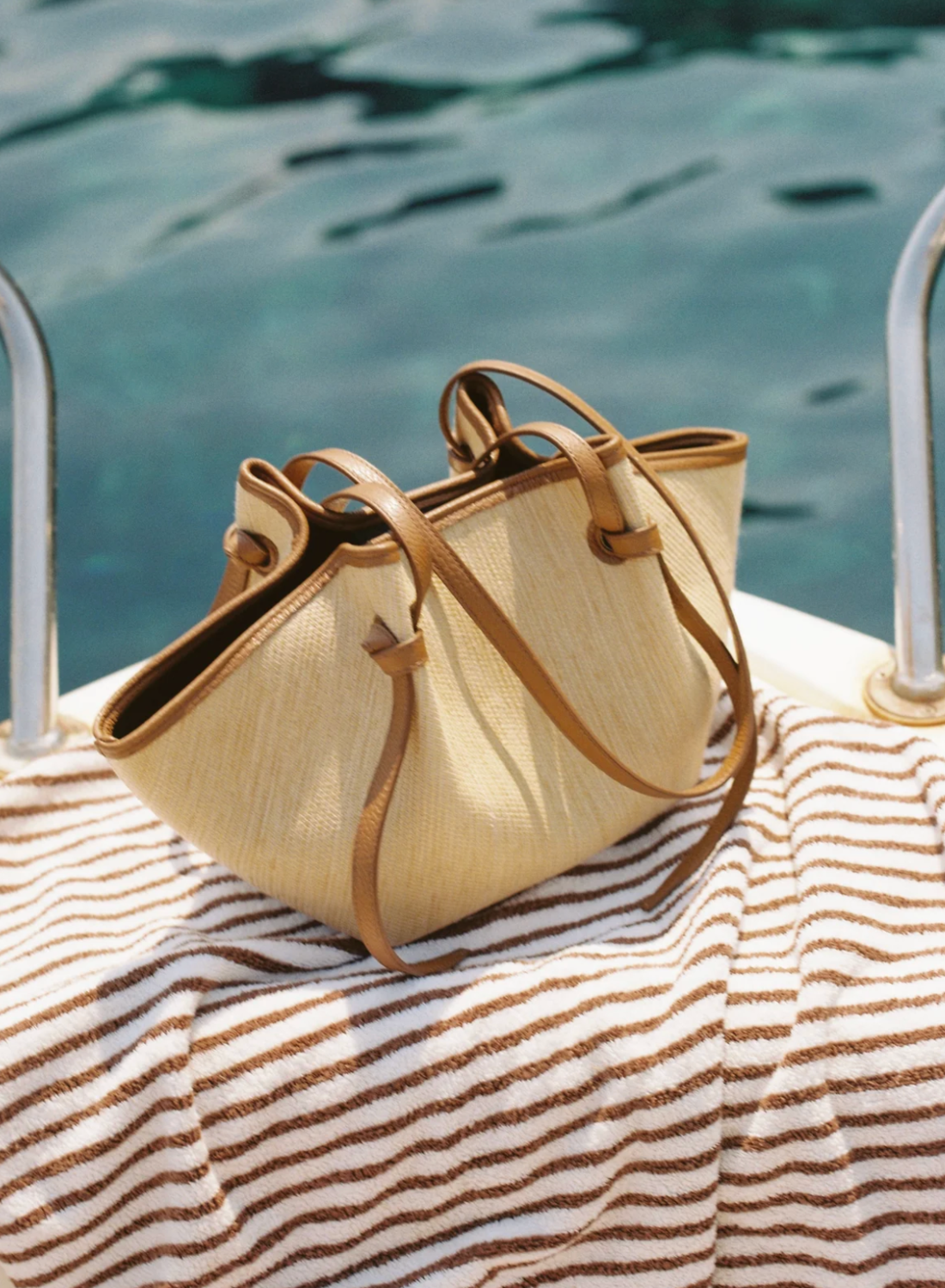 Raffia Bag with leather handles by the water