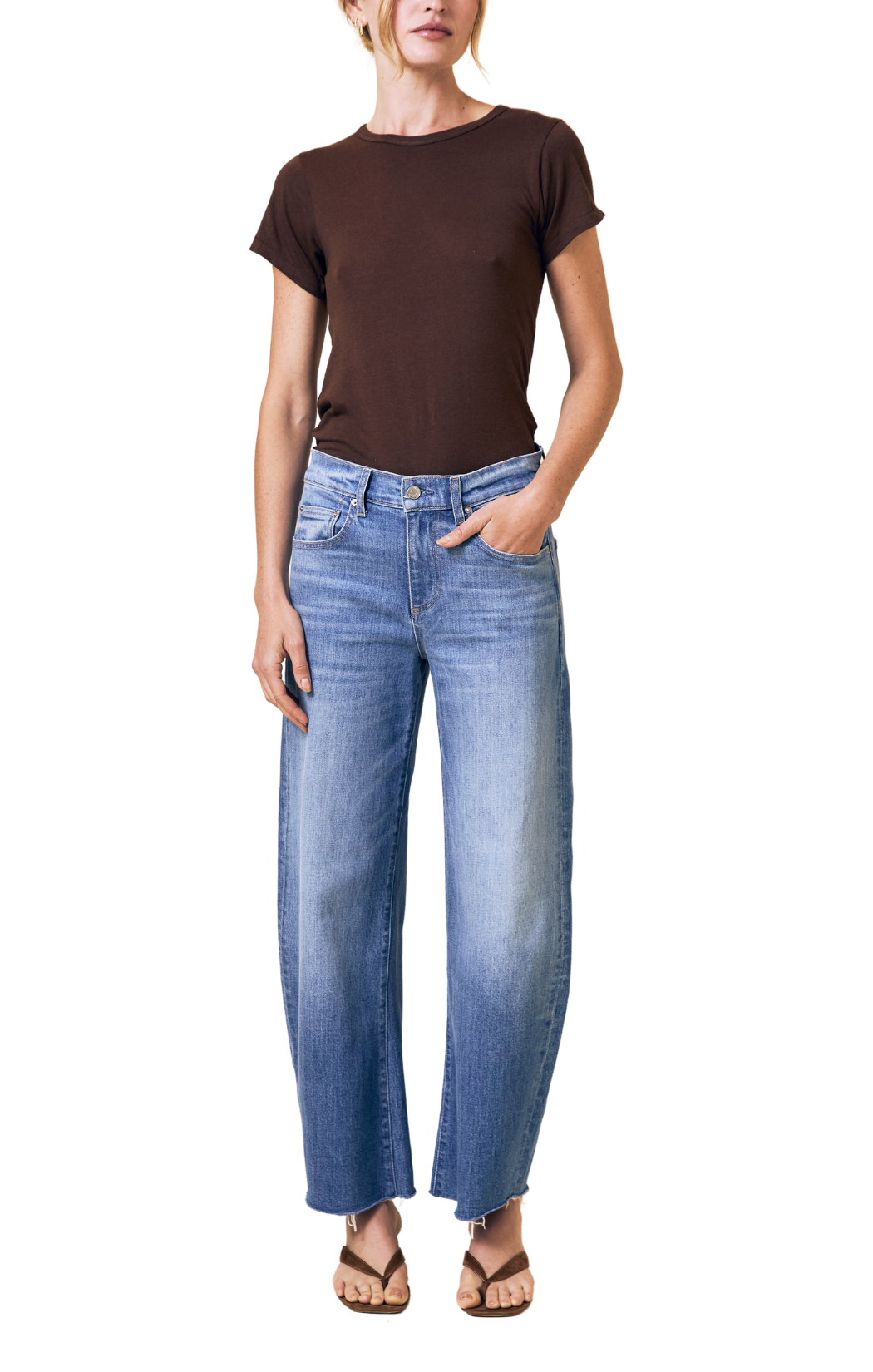 Person wearing a brown t-shirt and blue jeans on a white background