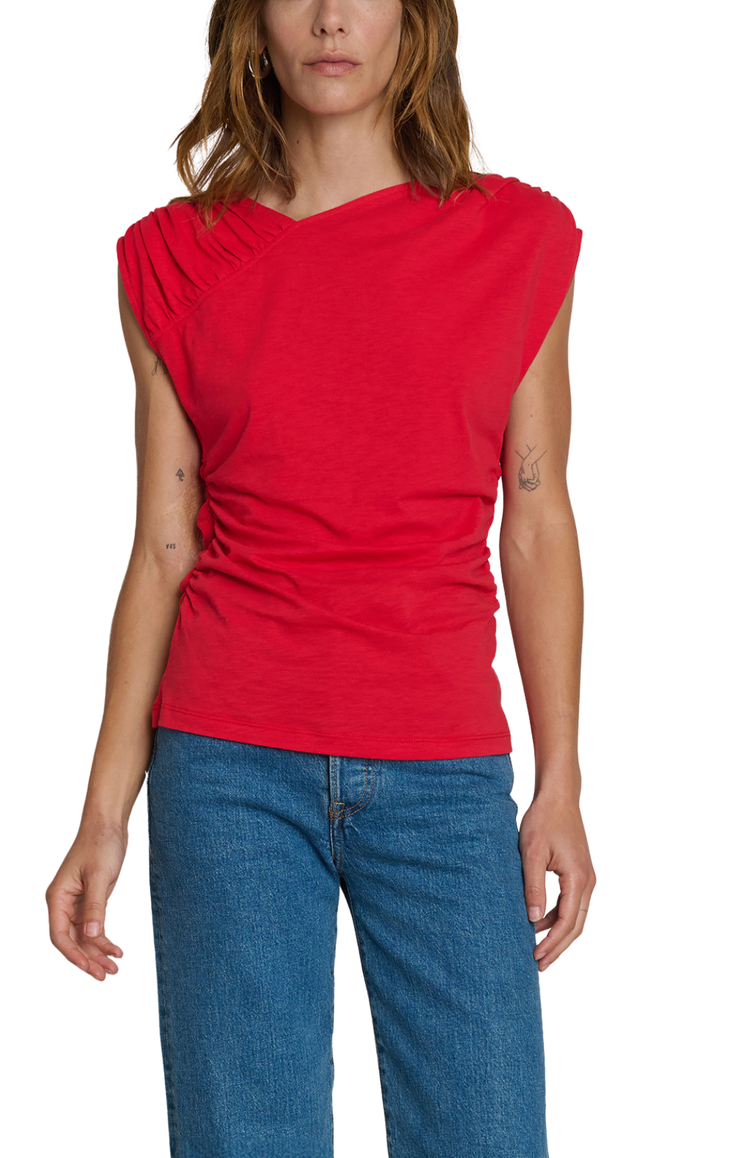 Woman wearing a red sleeveless top and blue jeans on a white background