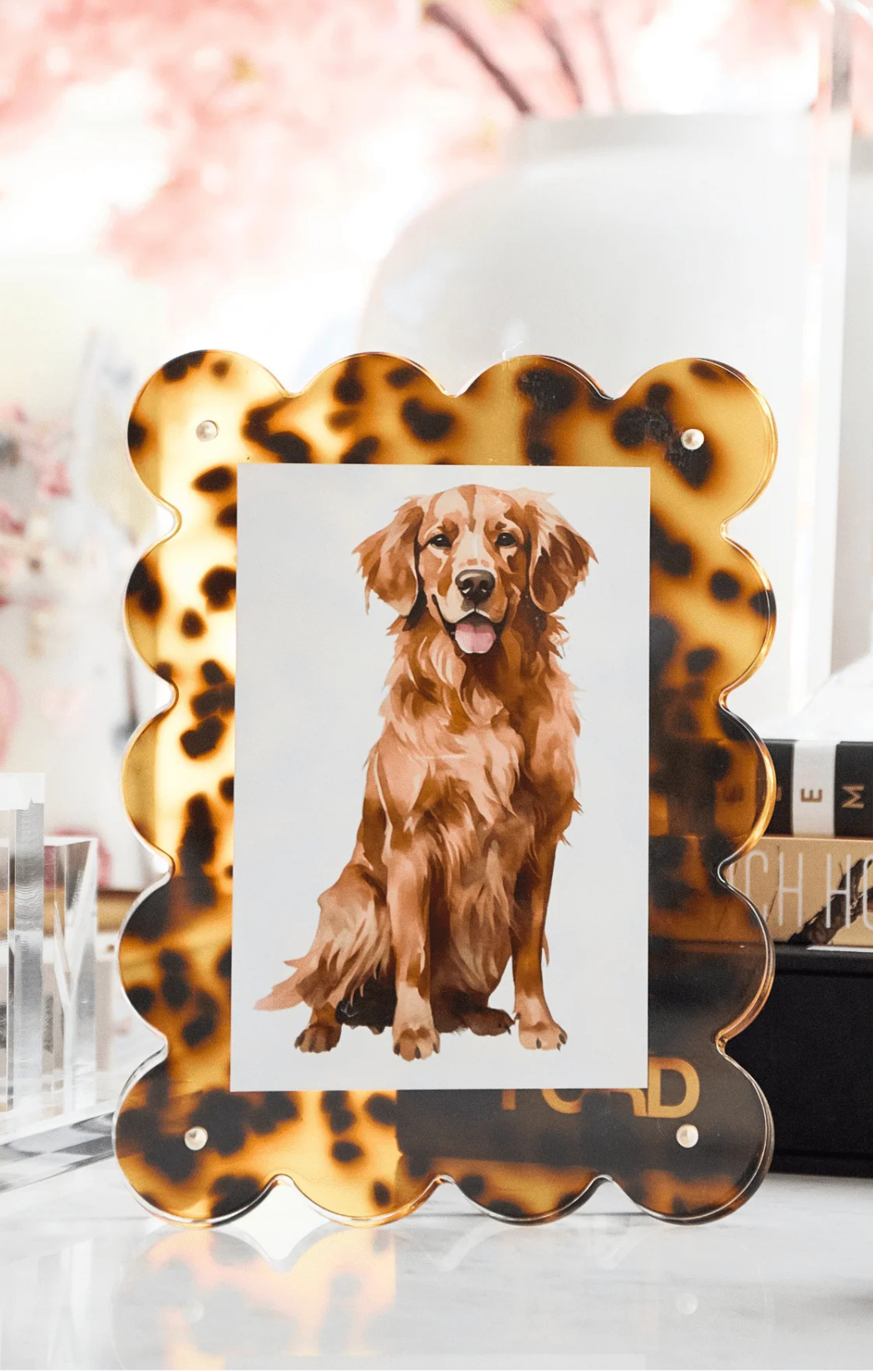 An acrylic picture frame with a tortoise shell-like pattern border, displaying a photo of a golden retriever dog.