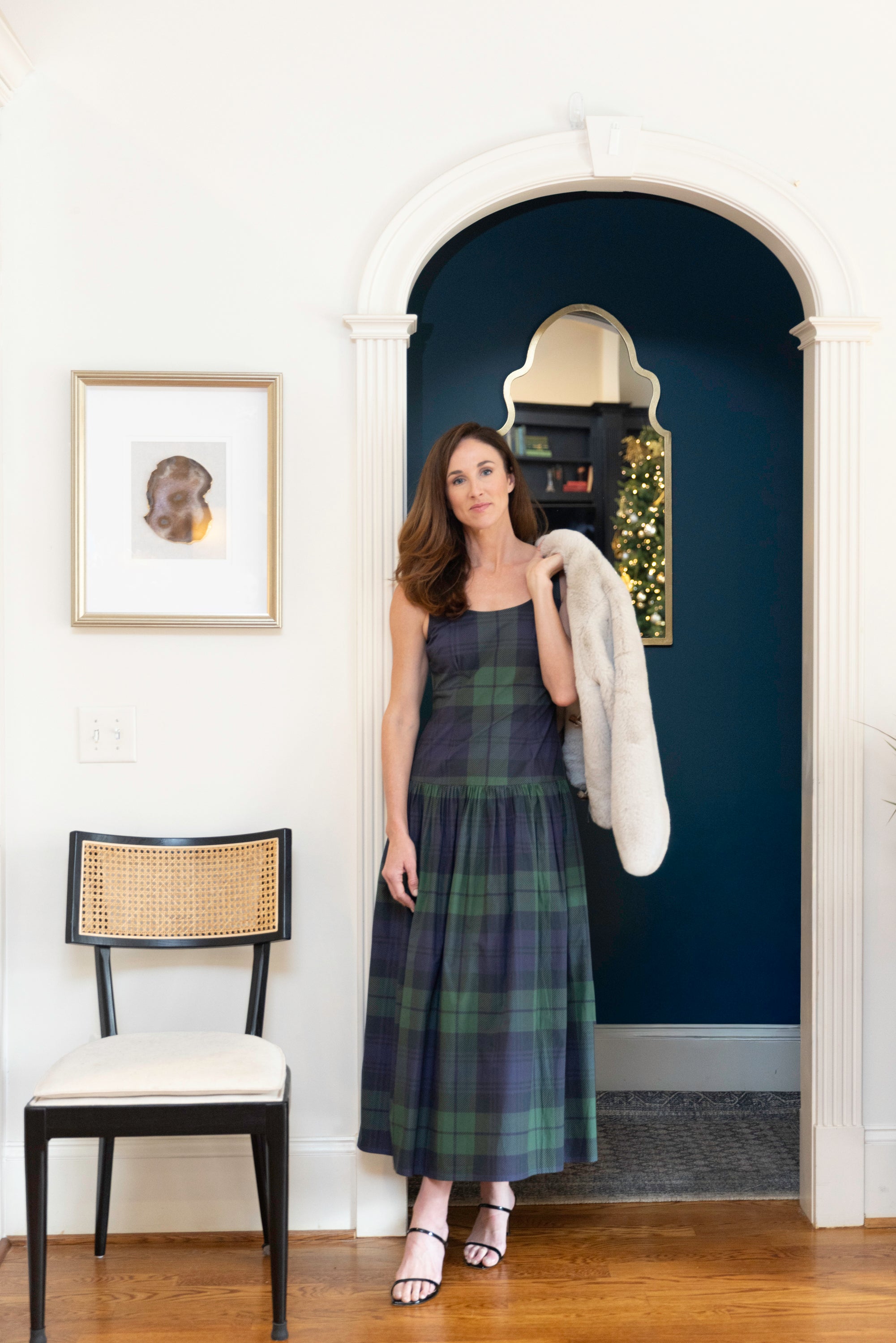 Woman in plaid dress with fur jacket on 