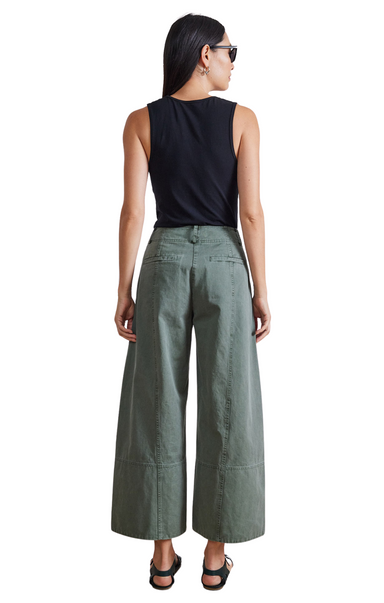 High fitted waist, wide cropped leg with a wide hem, slash pockets at front, welt pockets at back, hook and bar closure. Apiece Apart Malou Wide Leg Green Pant.