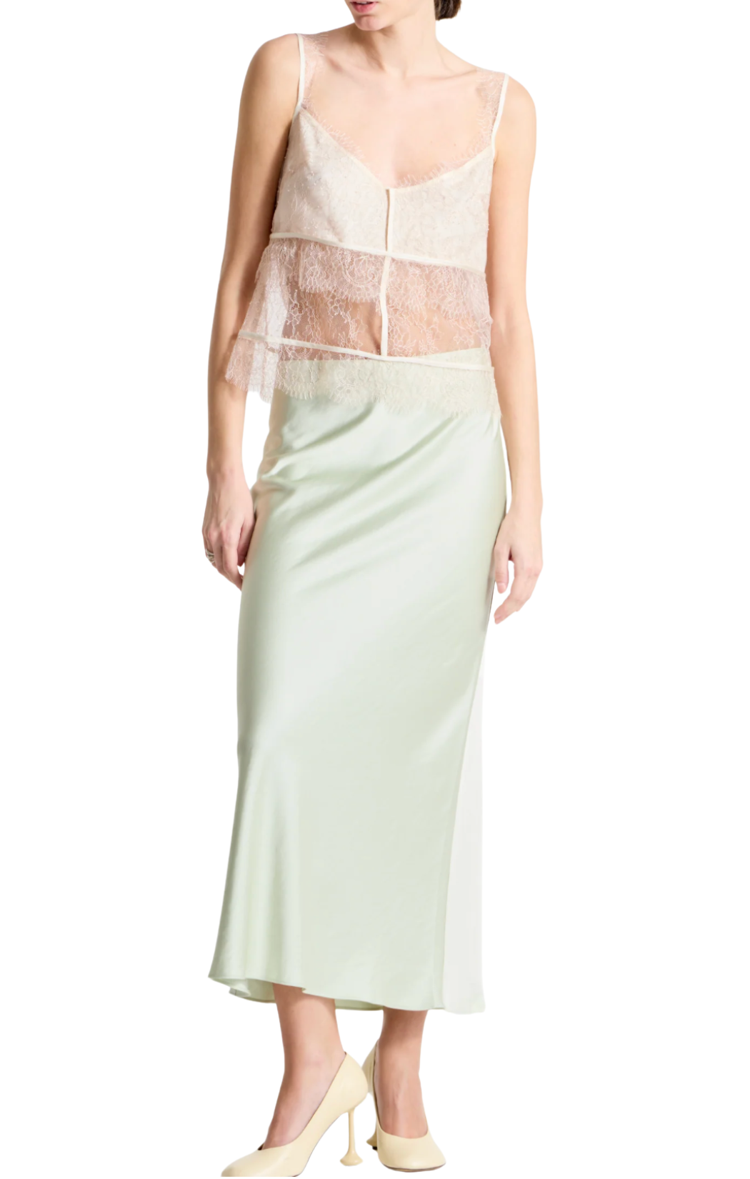 Light mint green bias-cut slip skirt crafted from charmeuse fabric. Designed with a fluid, body-skimming drape, it sits at the waist. Easy pull-on 