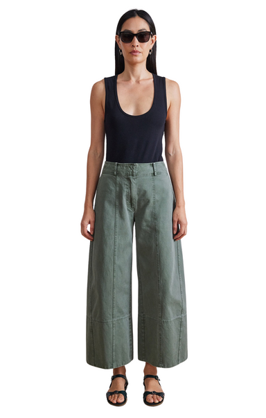 High fitted waist, wide cropped leg with a wide hem, slash pockets at front, welt pockets at back, hook and bar closure. Apiece Apart Malou Wide Leg Green Pant.