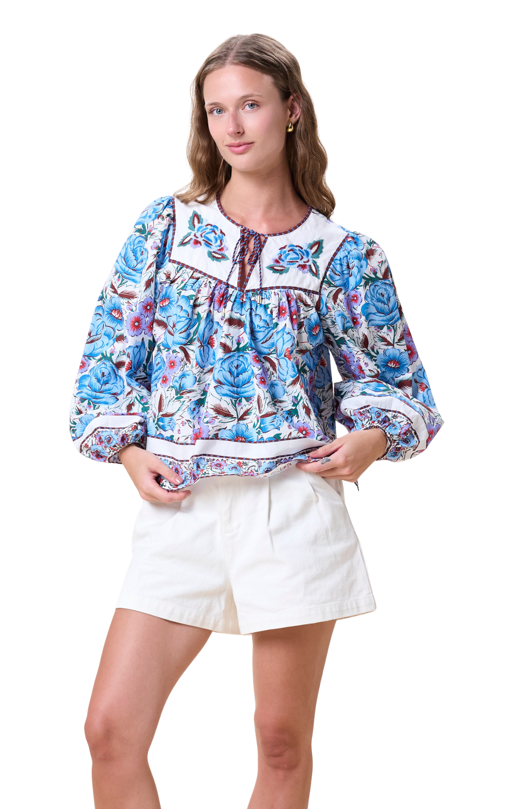 Blue floral blouse with puff sleeves, white placket at the chest with matching embroidered flowers and a simple small rope tie at the neck line.