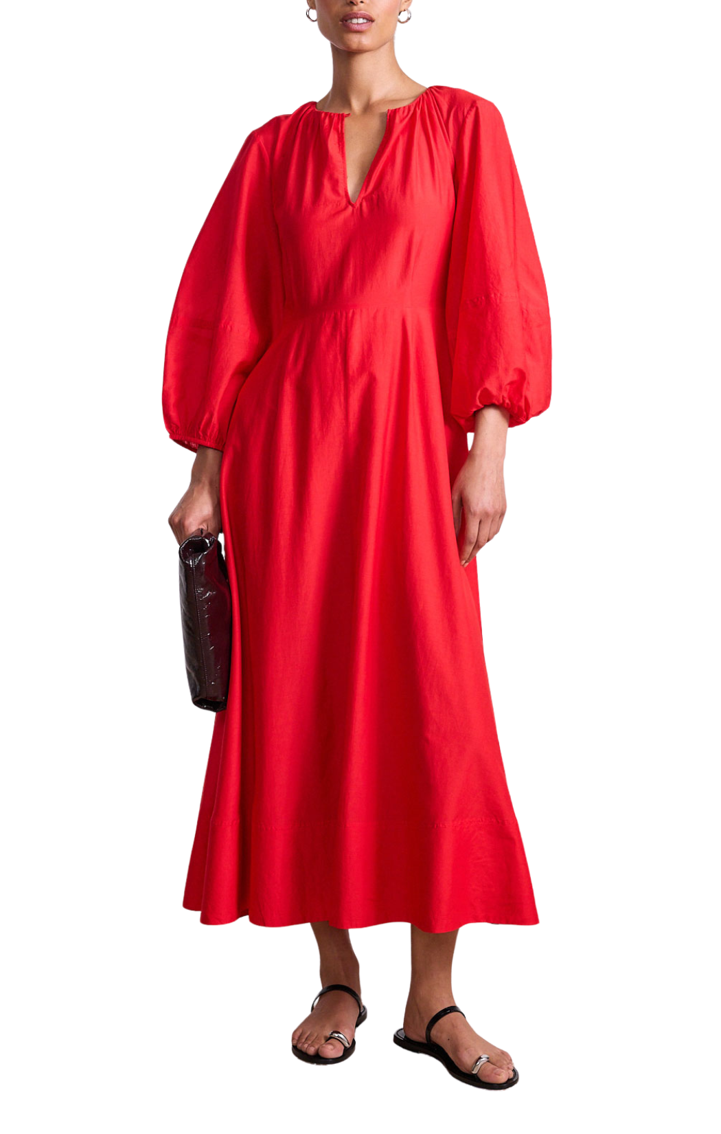 Woman wearing a red dress with balloon sleeves on a white background