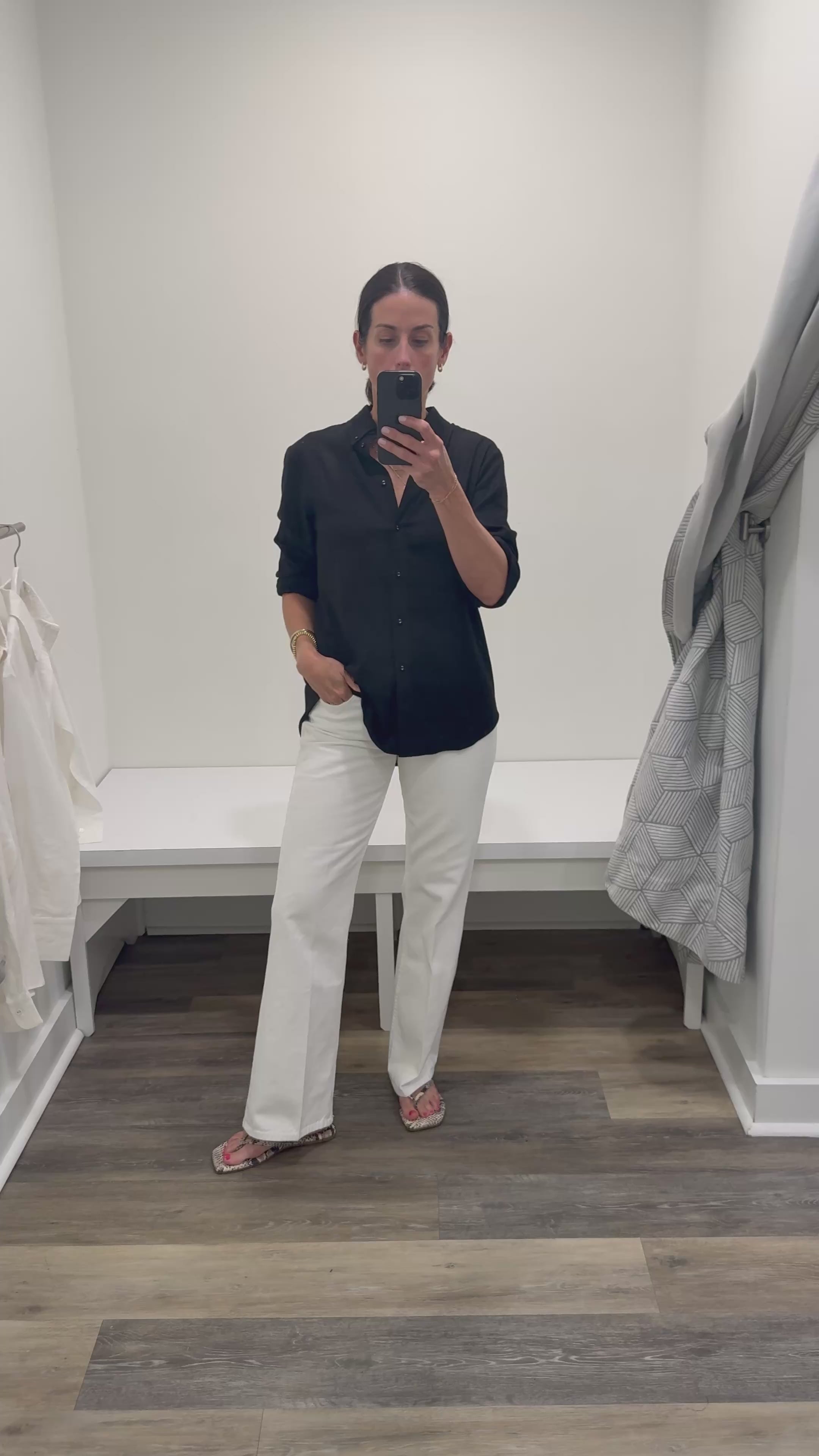 Woman in black linen button  down and white denim. 