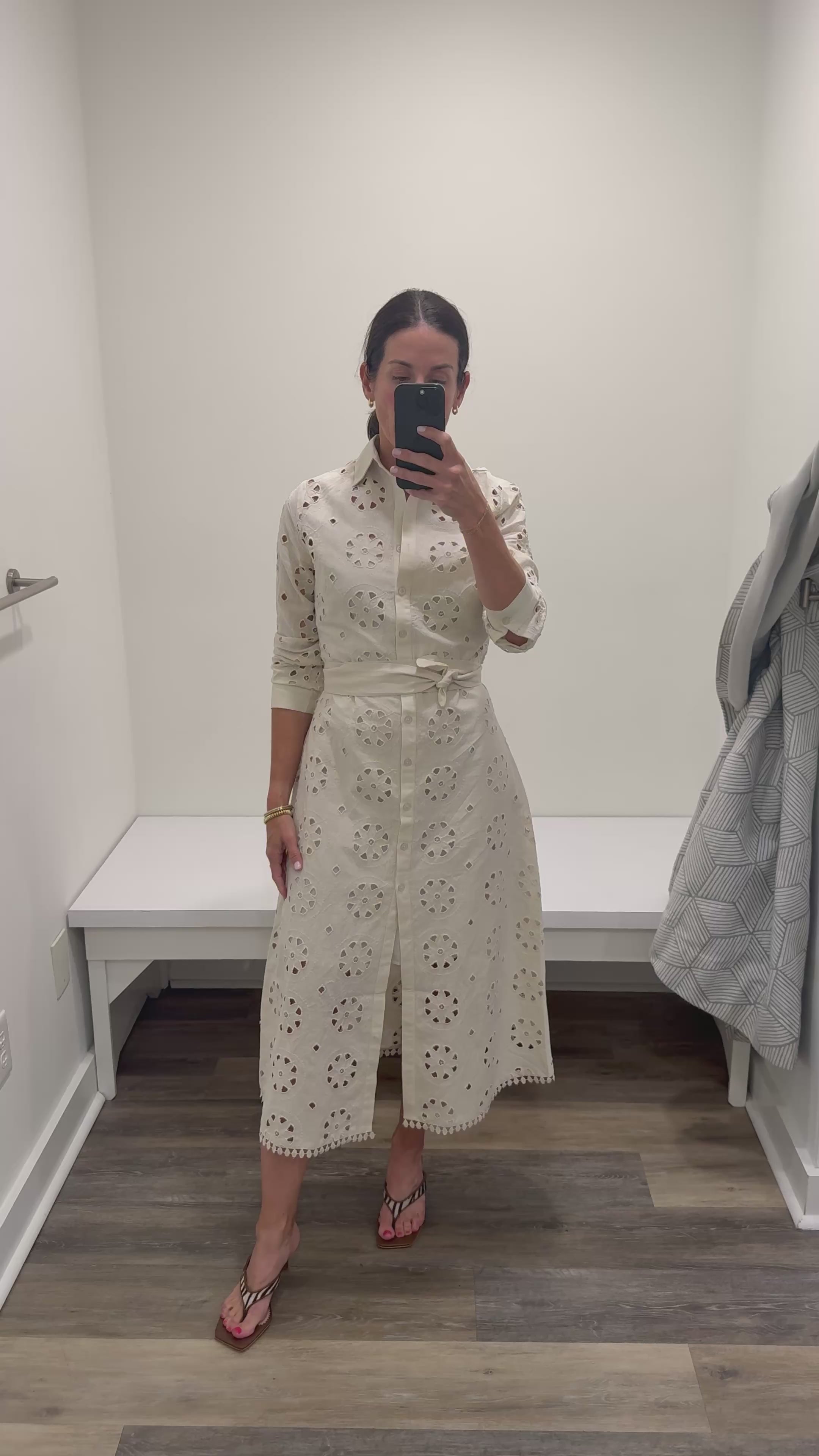 Woman in cream eyelet maxi shirt dress.