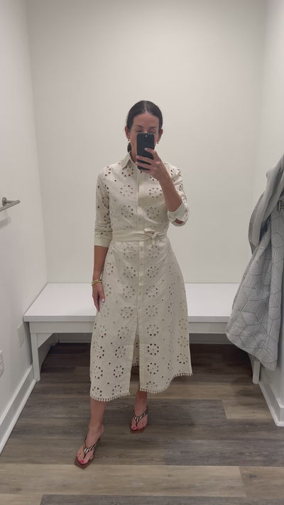 Woman in cream eyelet maxi shirt dress.
