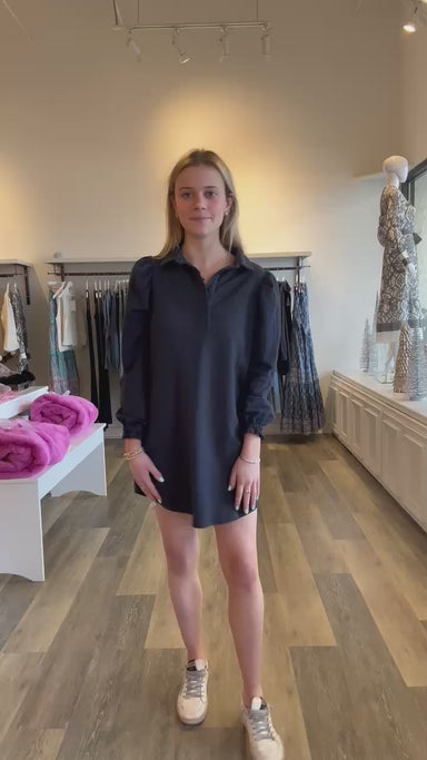 With a traditional structured collar and a looser fit, the Kent Dress by Sundays offers an effortless, menswear inspired look for casual days. This thick cotton navy dress features subtly puffed sleeves cinched with ruched cuffs for an added feminine touch. Pair with sneakers or boots to complete the look.